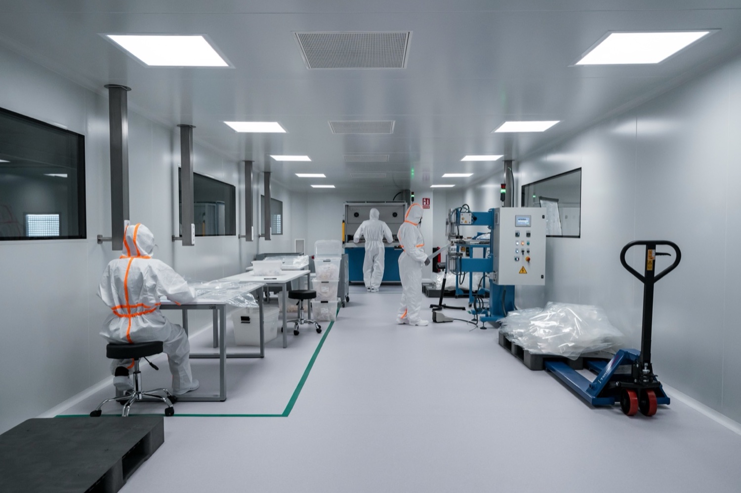 Operators building medical devices on the assembly floor of a Southern California cleanroom